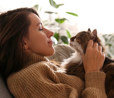 A woman and a cat looking at each other