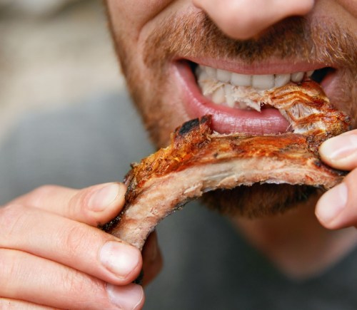 A man eating meat
