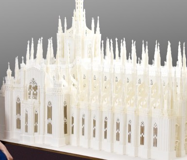 Indian baker Prachi Deb pictured next to her royal icing structure of the Milan Cathedral