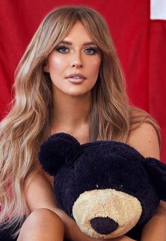 Faye Winter poses naked with a teddy bear in front of a union jack