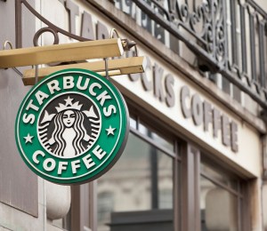 Starbucks sign hanging from a store front in London